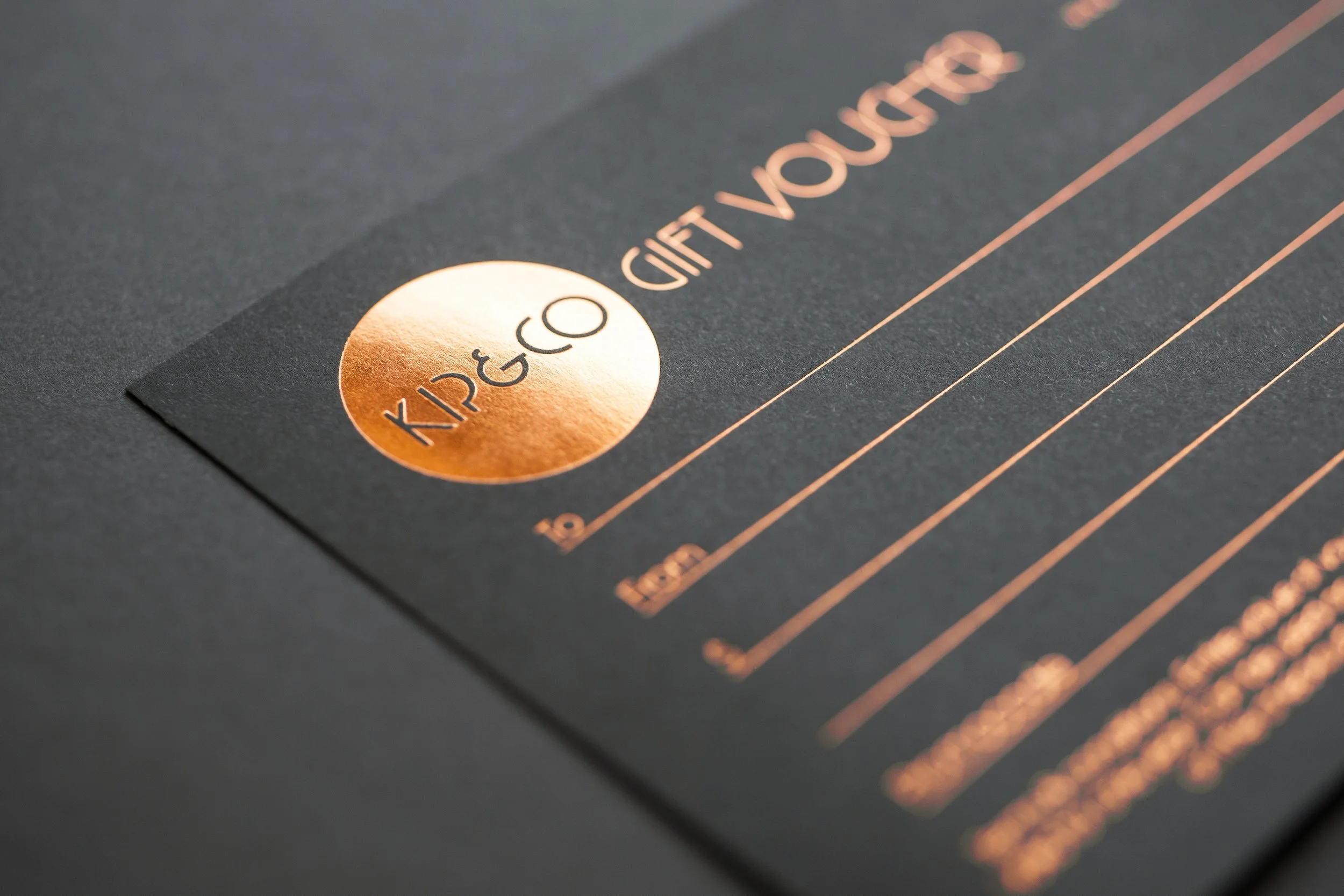 Gold foil embossed art deco style logo on gift voucher for Kip&Co.