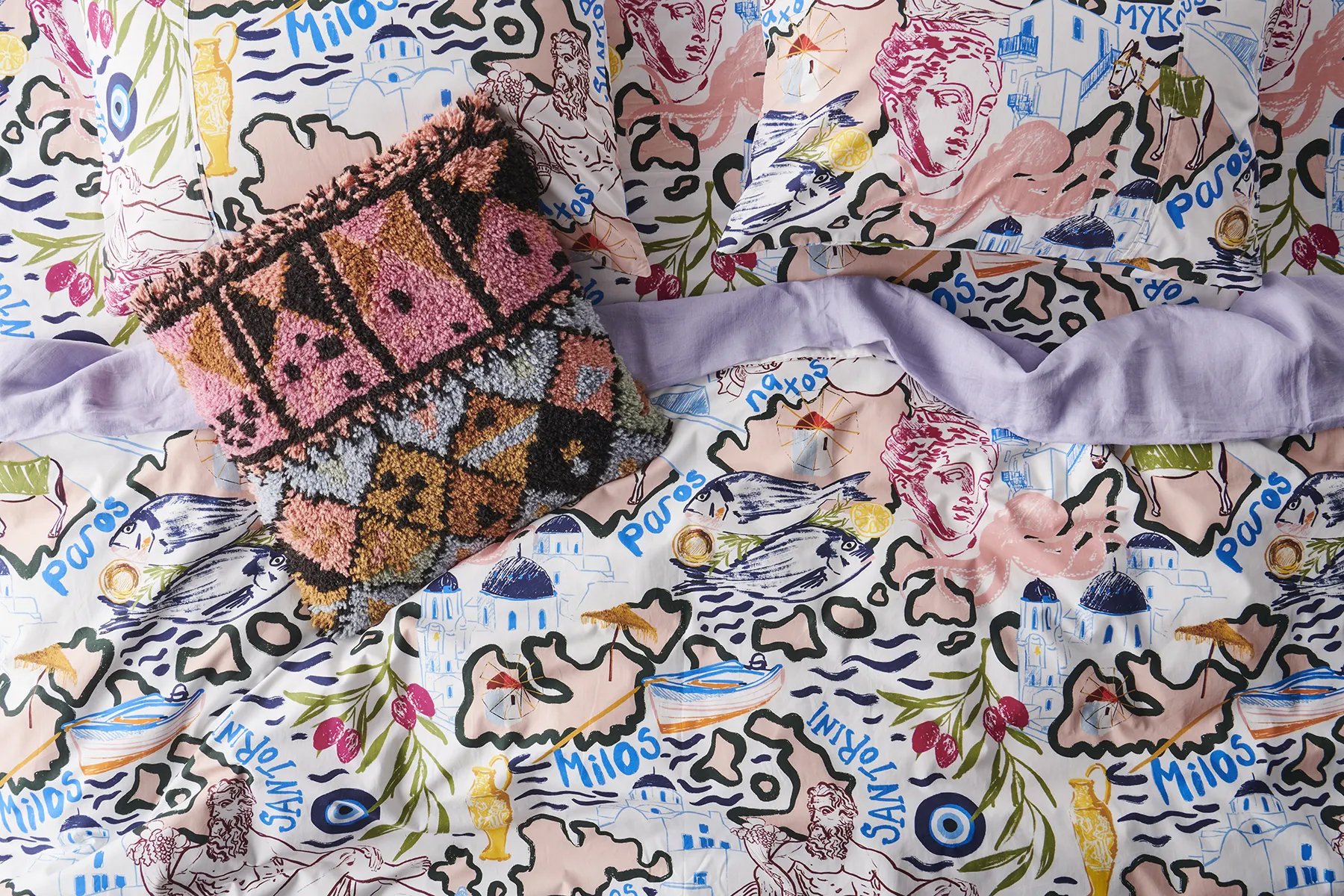 Kip&Co repeat print textile design for bedding, homewares and apparel. Illustration of greek islands including greek statue, fish, evil eye, donkey, olive branch, windmills, boats, beach umbrellas.