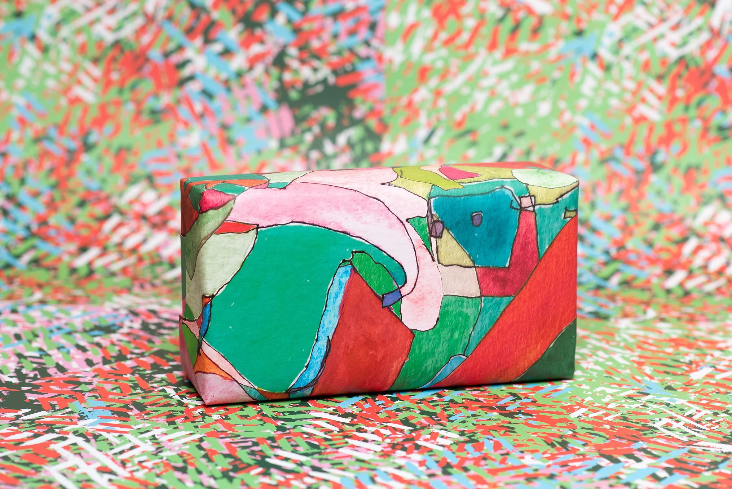 Roscher Creative uniquely colourful hand painted designs created for wrapping paper project with and drawn lead lighting shapes in pink, greens and reds.