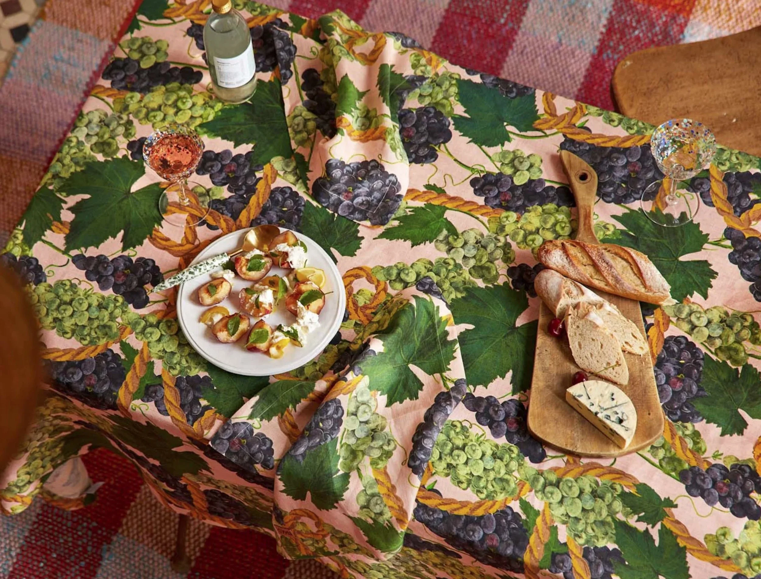 Hand illustrated grapes and rope on a peach background. Textile design and illustration on linen tablecloth.