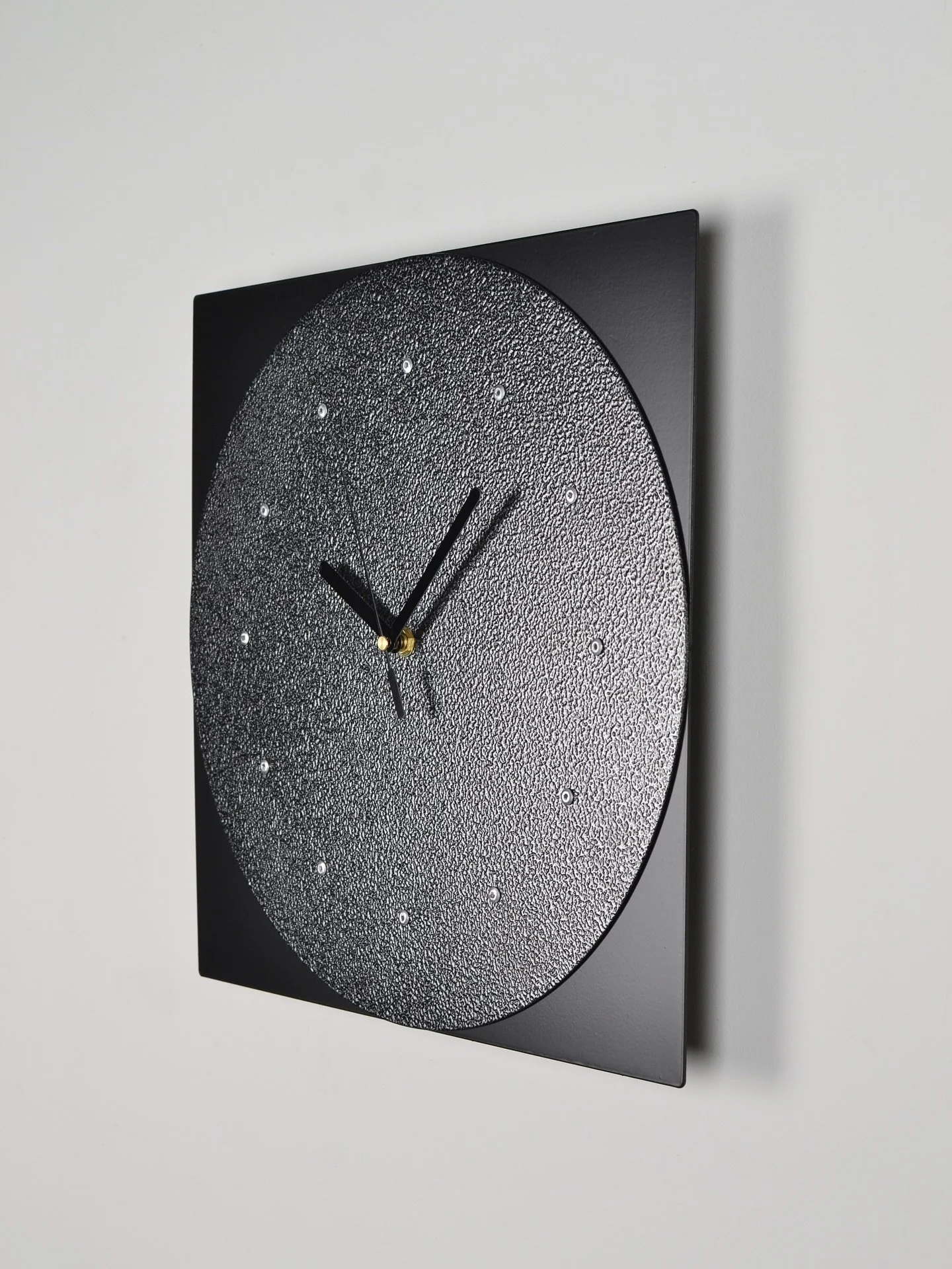 Timepiece N&ordm;5 is made from laser cut aluminum&mdash;the center is powder-coated in a silver vein hammertone that has a textured finish and the corners are powder-coated in matte black.

Limited first edition of 12 pieces released in July 2025 as