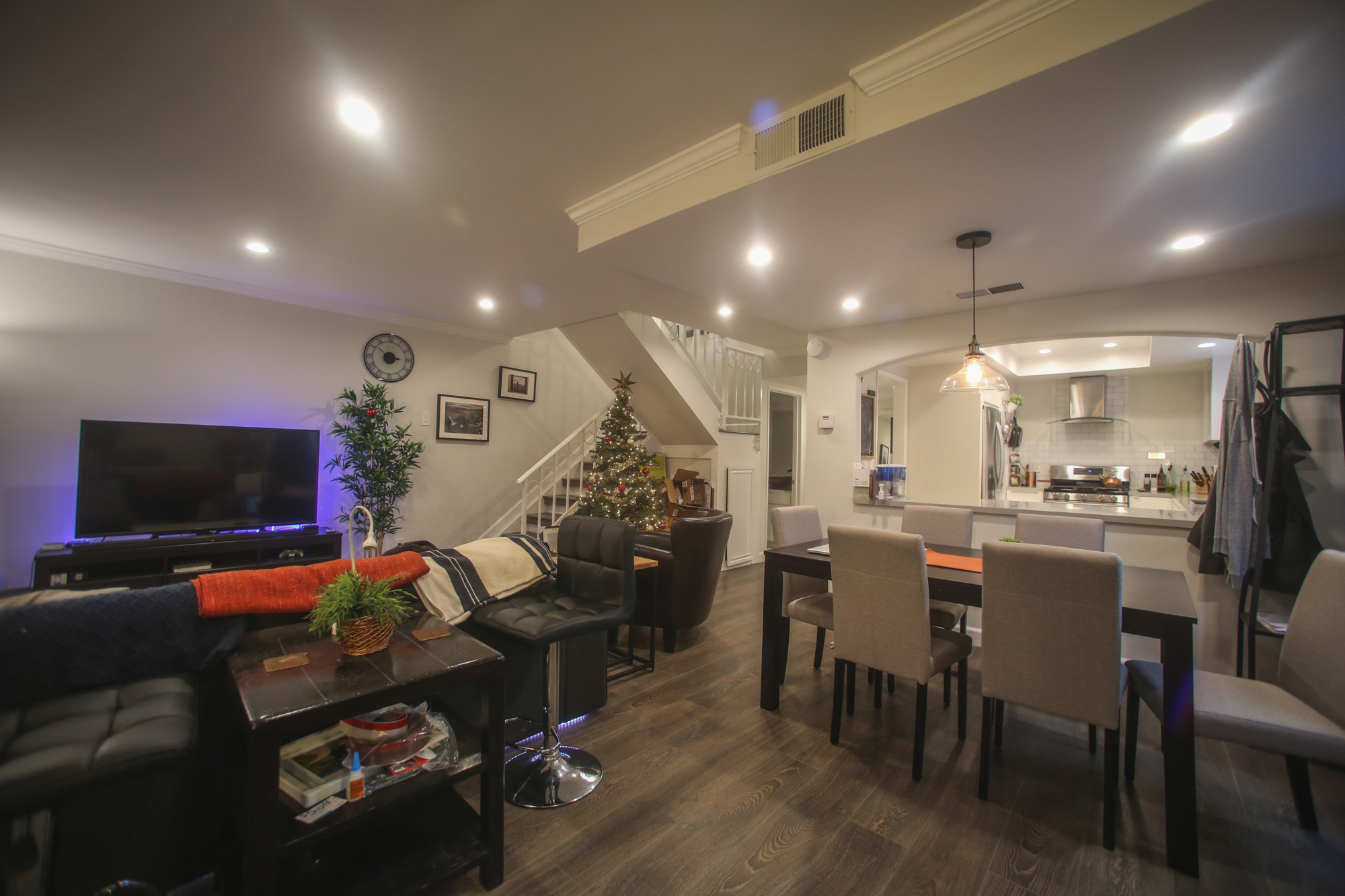  I love the living room. Opening up the wall on the right made such a big difference. I got a black/gray 6 person dining table, edison pendant bulb, and some nice furniture. I decided to put a small table and bar stools behind the couch for people to