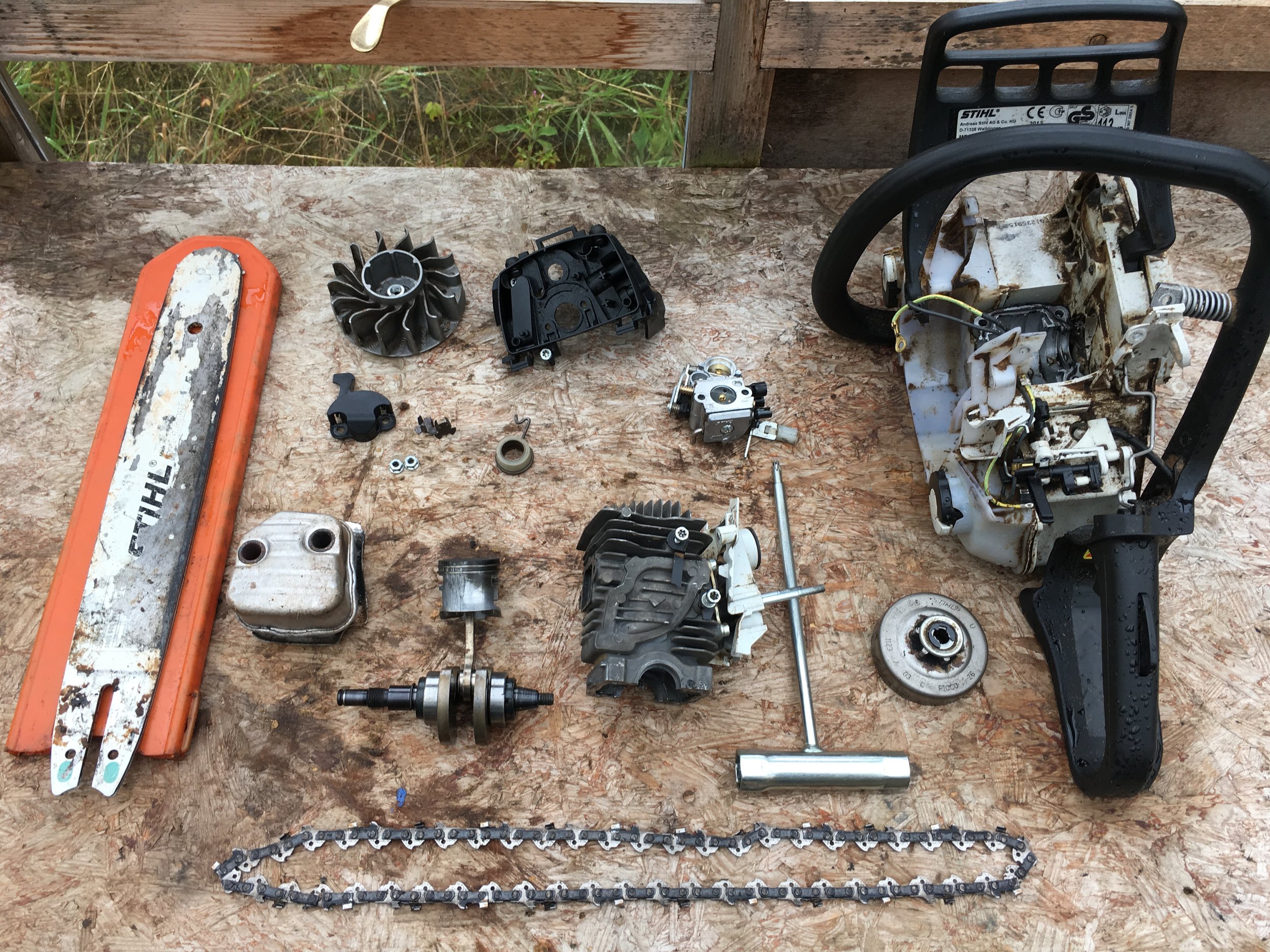 My chainsaw in pieces as I try to mend it...yet again!