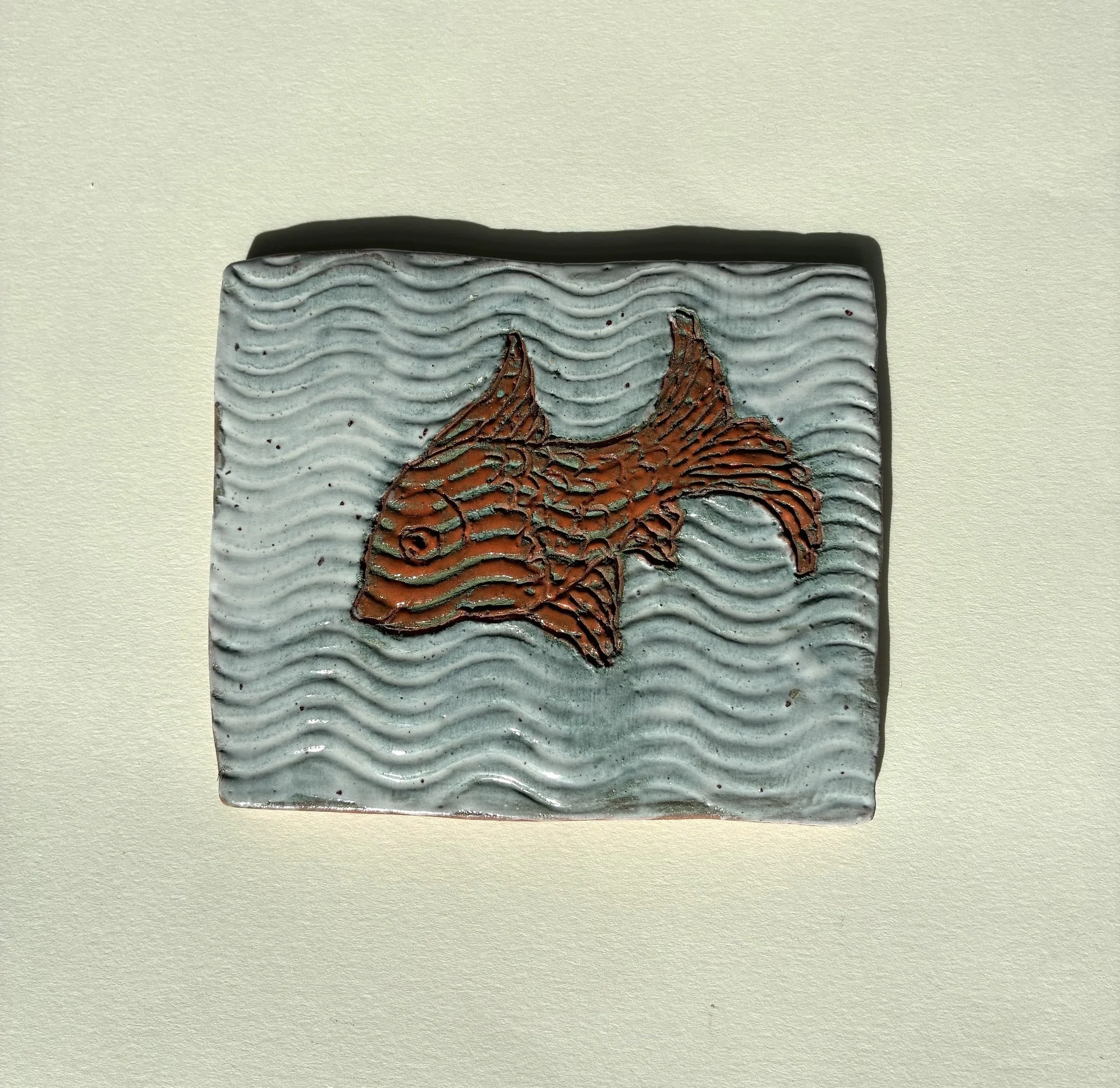    Fish ceramic tile.    Terracotta clay sgraffito, slip and glazes.  2026 