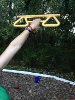 4/20/13  Hanging by left hand from kids' bar on playground.