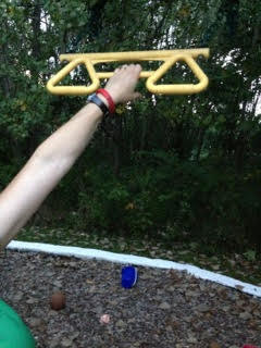 4/20/13 Hanging by left hand from kids' bar on playground.