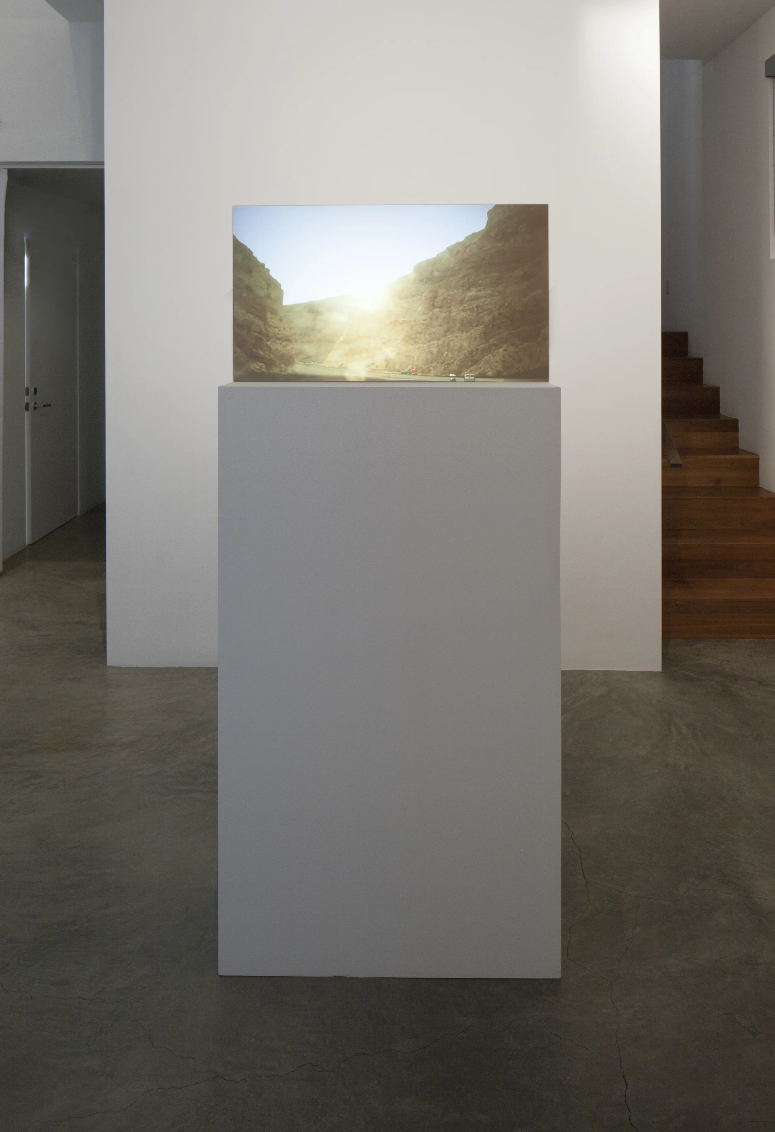 Installation View (Shulamit Gallery, 2014) Prodigal Sun, 2012 Single Channel HD Video Projection onto Glass in Pedestal, No Sound, TRT 2:20, Looping 69 x 30 x 12 Inches (Pedestal and Glass)