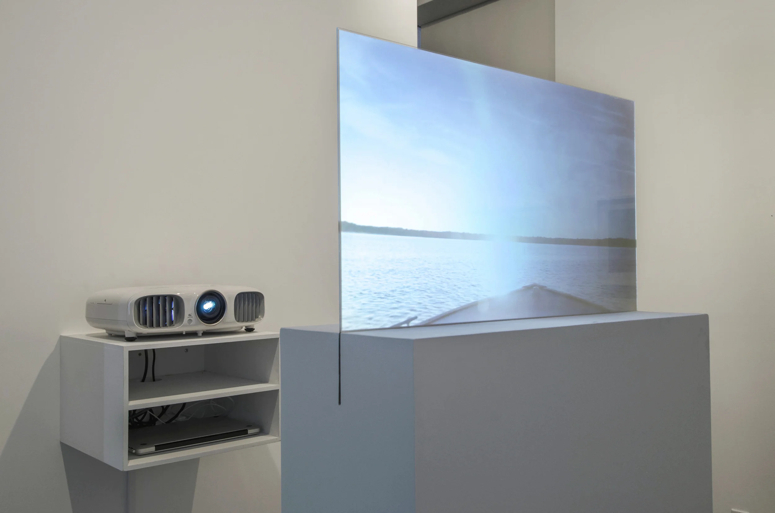 Installation Detail (Shulamit Gallery, 2014) Prodigal Sun, 2012 Single Channel HD Video Projection onto Glass in Pedestal, No Sound, TRT 2:20, Looping 69 x 30 x 12 Inches (Pedestal and Glass)