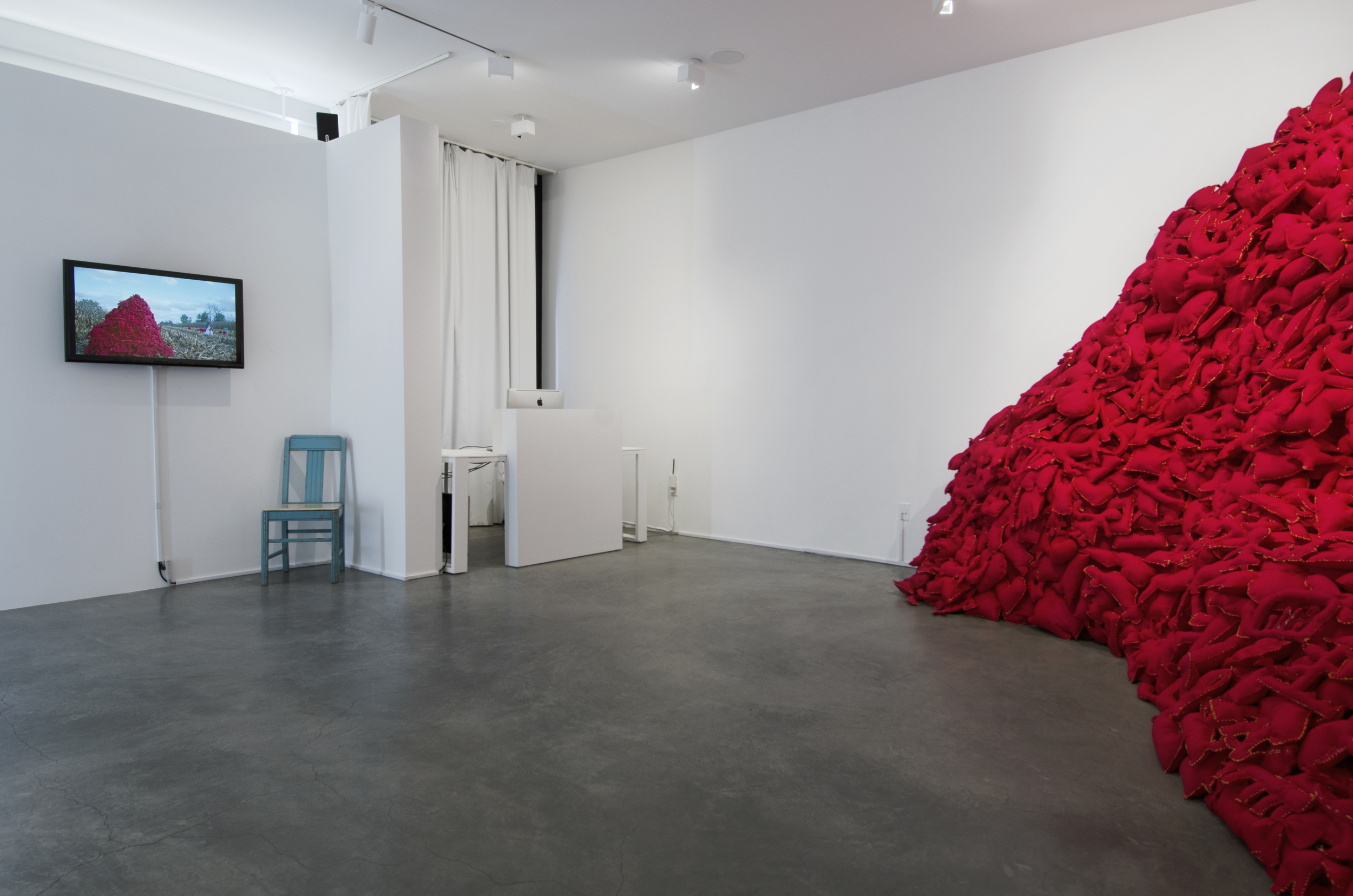  Installation View&nbsp; (Shulamit Gallery, 2014)   The Pile,&nbsp; 2014 Single Channel HD Video Projection with Sound (16mm Film), TRT 12:00, Looping; Digital C-Prints; Hand-Stitched Red Felt Objects Installation Dimensions Variable 