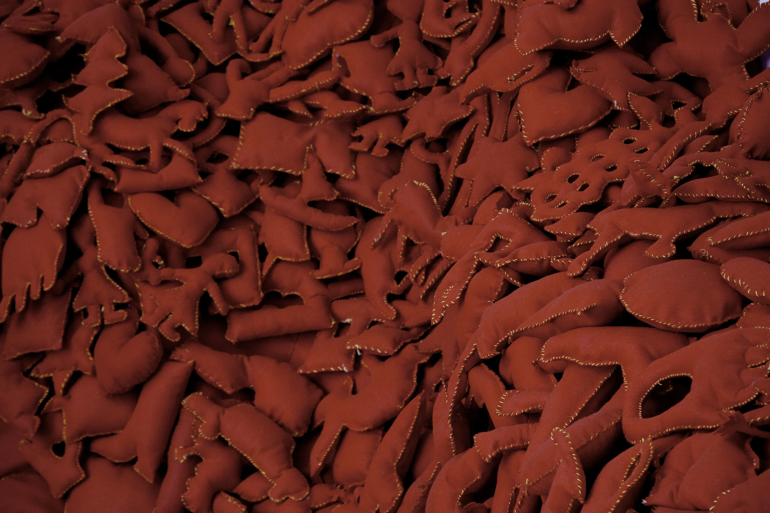 Installation Detail of Hand-Stitched Red Felt Objects (Shulamit Gallery, 2014) The Pile, 2014 Single Channel HD Video Projection with Sound (16mm Film), TRT 12:00, Looping; Digital C-Prints; Hand-Stitched Red Felt Objects Installation Dimensions Variable