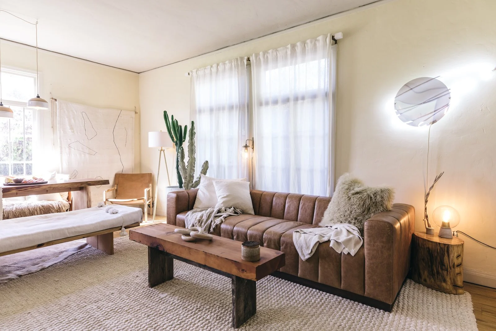 Much of the furniture in Zee's Oakland abode—including her coffee table, dining table, and large bench—was made by herself along with fellow woodworker Katie Gong. The pendant lamps are by San Francisco–based illustrator and ceramicist Sam Lee; a Saffron + Poe chair sits in the corner backed by a minimalist Küdd:krig Home tapestry. The neon art on the wall is by local artist Meryl Pataky, and the ceramic knots are by New York City–based MQuan Studio.