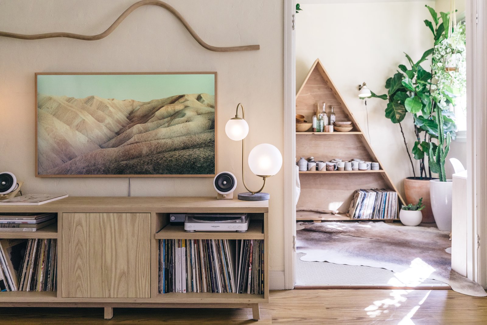 The credenza was handmade by San Francisco furniture maker Four / Quarter, while Katie Gong's wood squiggle rests above a Samsung Frame TV to add balance to the space.