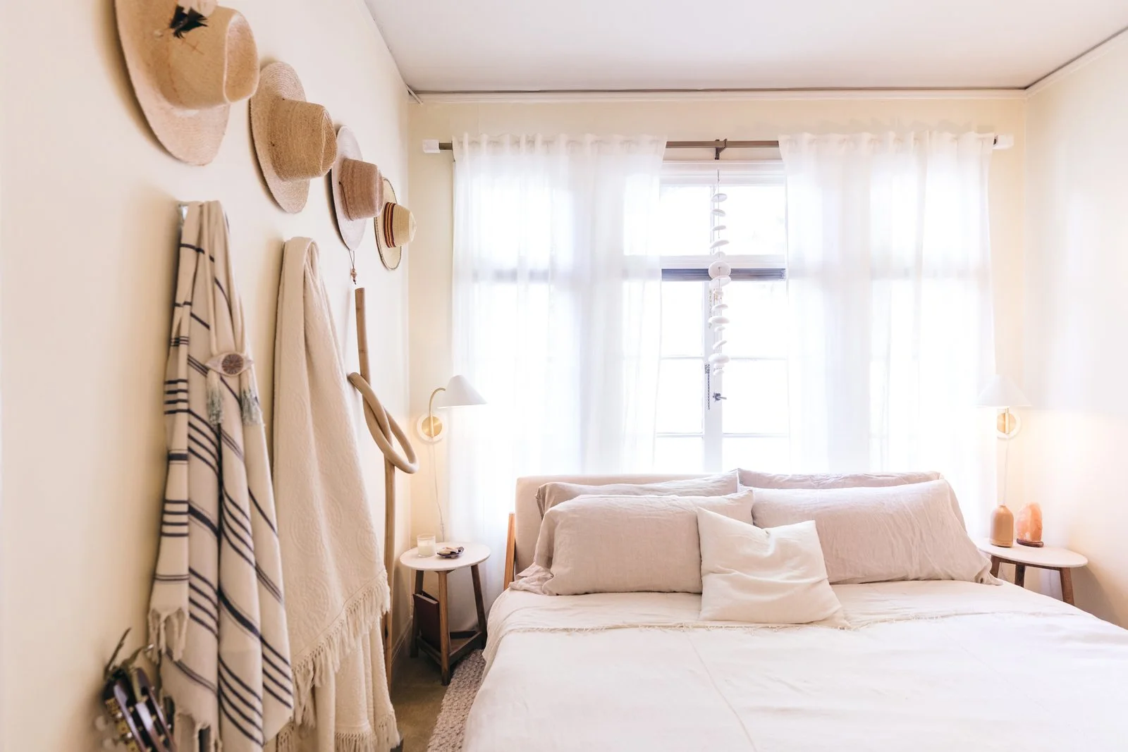 Zee's bedroom is filled with her hat collection as well as a wood knot from Katie Gong, the most represented of artists in her space, and hanging bells from Mudpuppy Ceramic Studio.