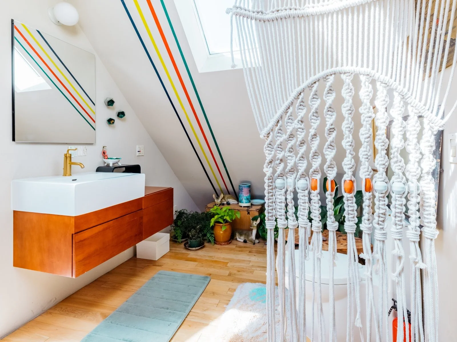 Windy's bathroom upstairs showcases the same stripes, as well as an array of plants and a porcelain deer nestled in the foliage. (Sothear Nuon)