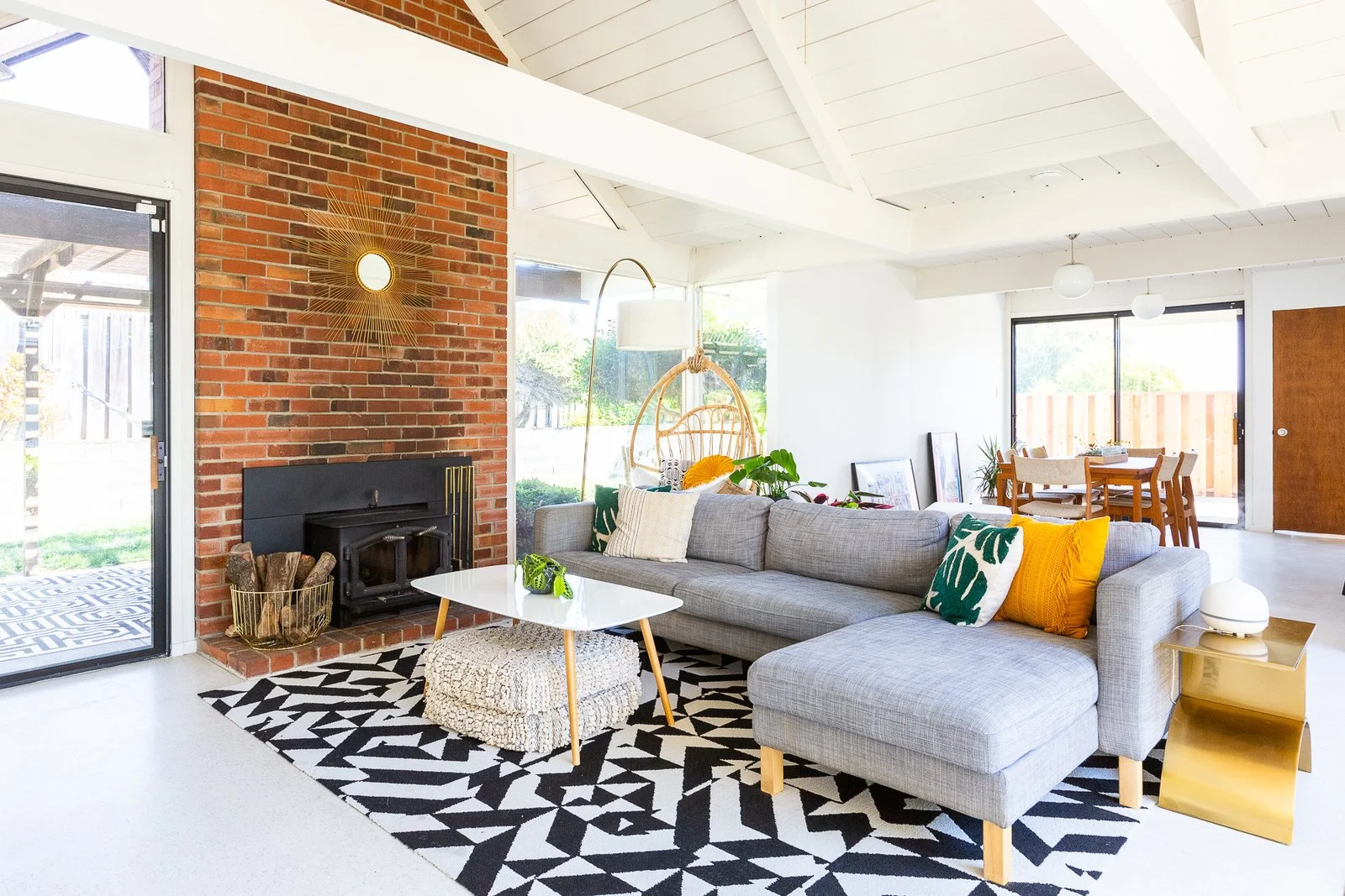 Encarnacion's living room is warm and cozy, with floor cushions under the table for extra seating. "One of my favorite pieces in the house is this brass table that is in the living room," she tells us. "When our diffuser is on it, it looks like a person doing Warrior 2 pose." (Gillian Walsworth)
