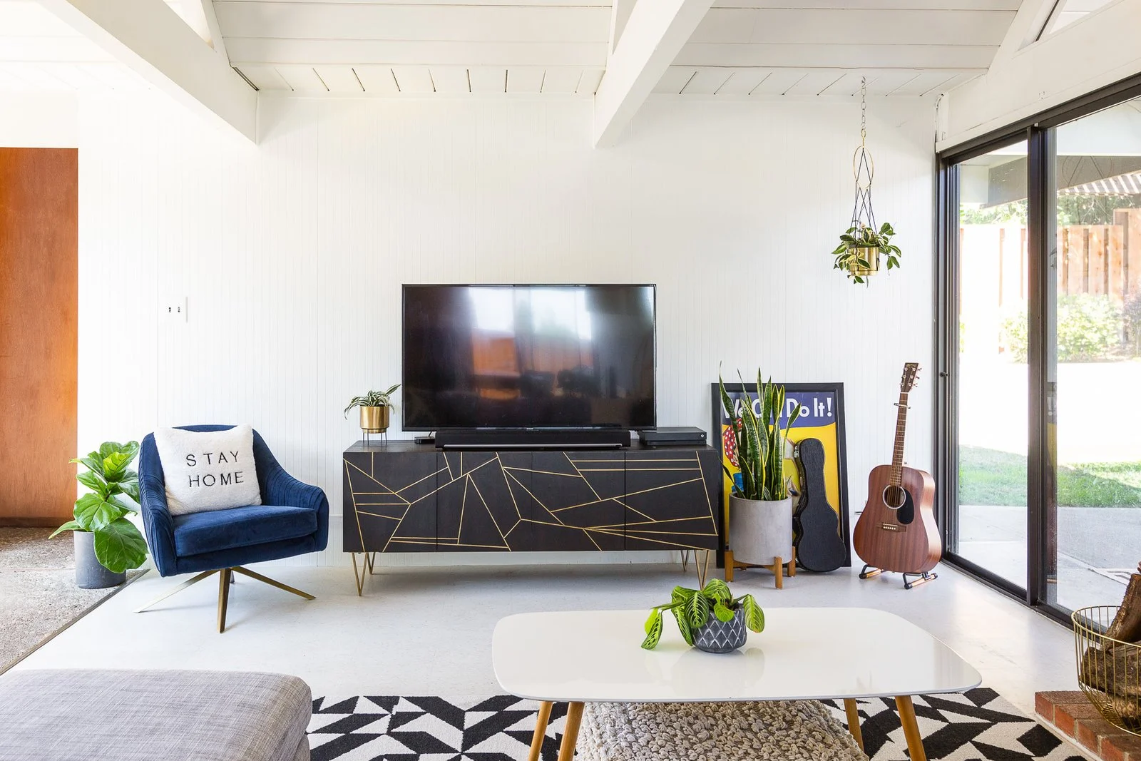 The living room exudes a bit of glam with jewel tones and gilded details. (Gillian Walsworth)