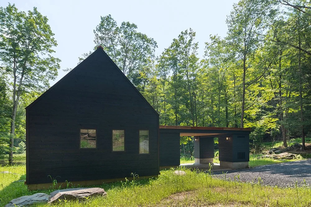 The back of the home and gable ends are covered in blackened cedar. (Bjorg Magnea)