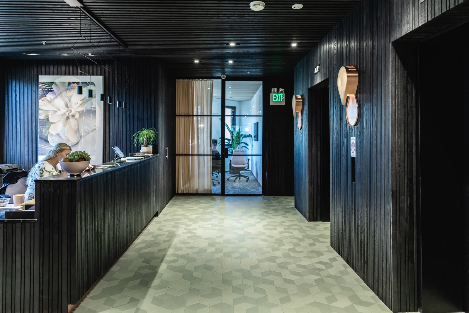 Textured black surfaces and exposed concrete pay homage to San Francisco's iconic Transamerica Pyramid, while Raw Edges for Mutina tiles break up the harsh lines with a muted color pop. (Sothear Nuon)