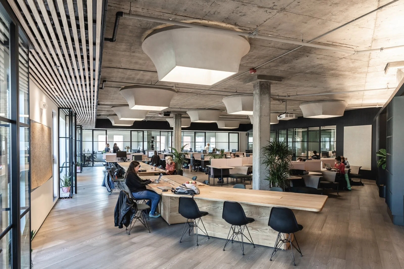 Solid ash communal tables and inky Eames chairs make up the communal area. (Sothear Nuon)
