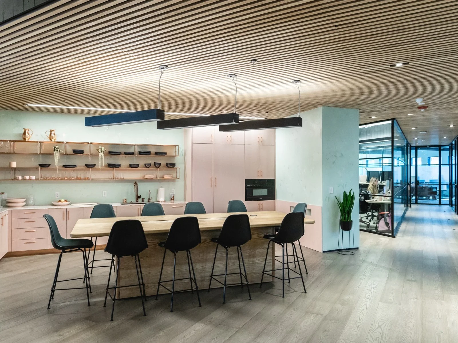 Pink quartzite finishes and blackened plywood bulkheads make up the kitchen area, along with ceramics from Year & Day. (Sothear Nuon)