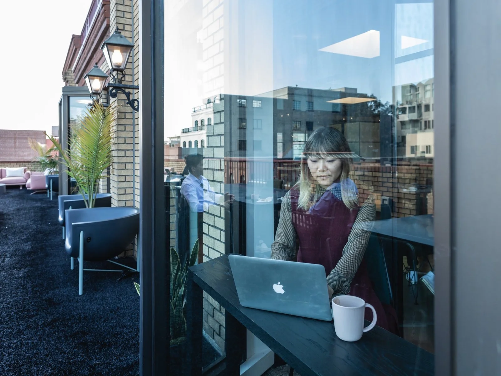 Jenny Xie, executive web editor, works in a phone booth overlooking the terrace. (Sothear Nuon)