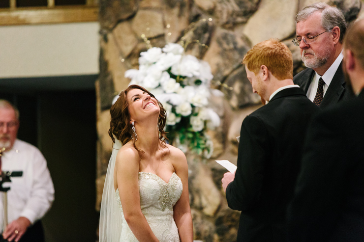 Bride laughing during her vows