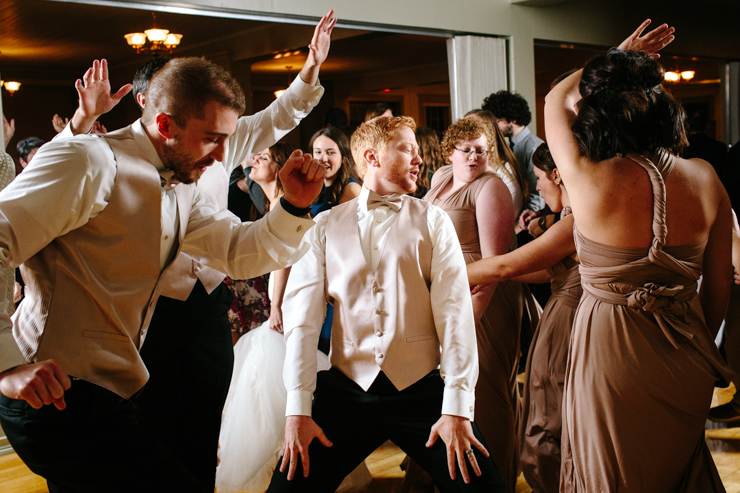 Groom dancing with crazy dance moves at the reception