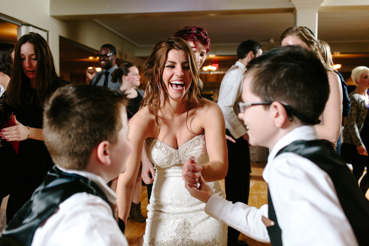 Bride dancing with her brothers at wedding reception