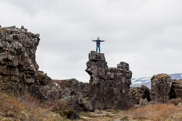 Man Climbing on rocks in Pingvellir National Park, Iceland