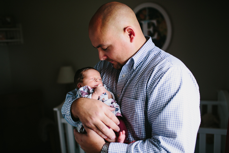 Dad with his newborn baby girl in her nursery photography 