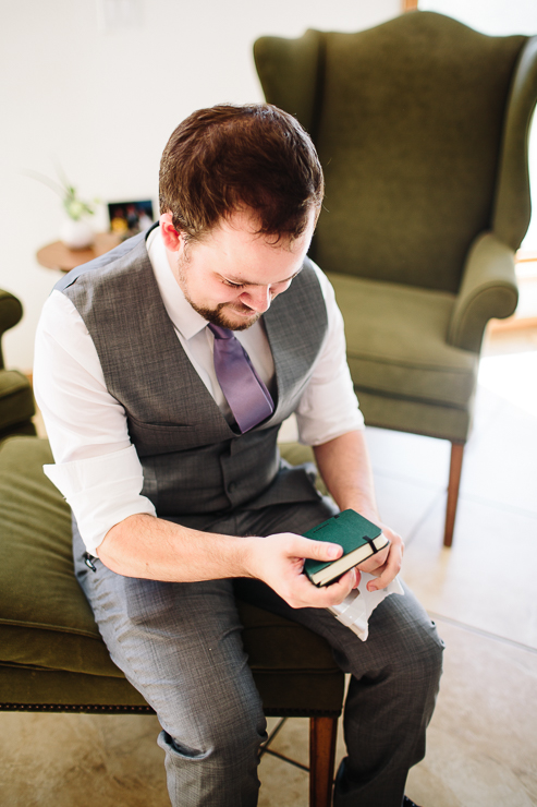 Groom reading a gift from his bride