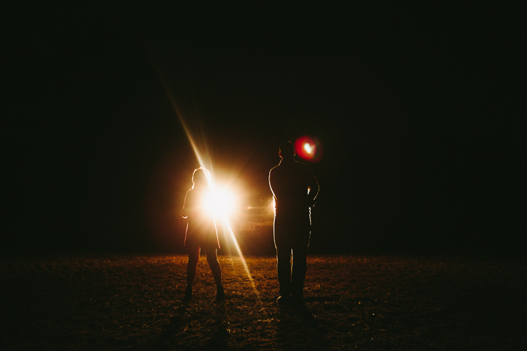 Nolan and Alyssa's Rustic Countryside engagement session dancing with smoke bombs in the headlights of a truck