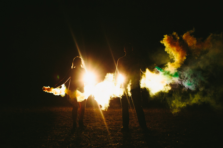 Nolan and Alyssa's Rustic Countryside engagement session dancing with smoke bombs in the headlights of a truck