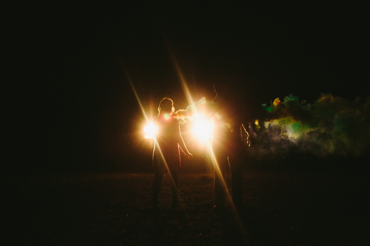 Nolan and Alyssa's Rustic Countryside engagement session dancing with smoke bombs in the headlights of a truck