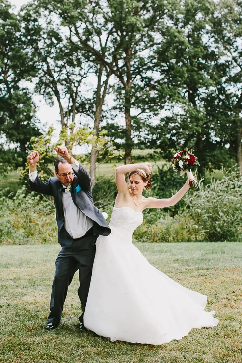 Bride and Father hip bumping during outdoor ceremony Kickapoo Creek Winery, Edwards, IL