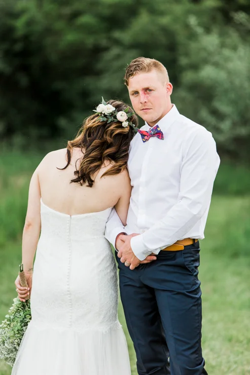 Bride and Groom's wedding portraits on childhood home's countryside hill