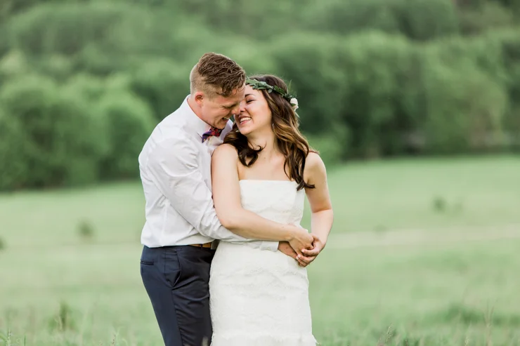 Bride and Groom's wedding portraits on childhood home's countryside hill