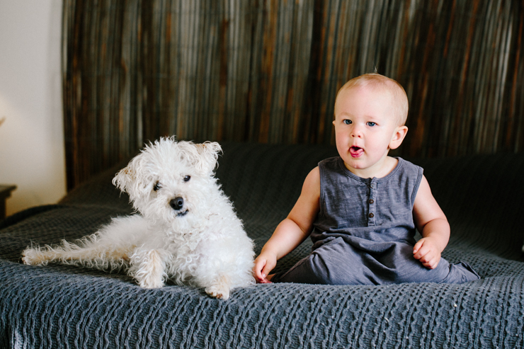Lifestyle photography one year old and puppy on bed