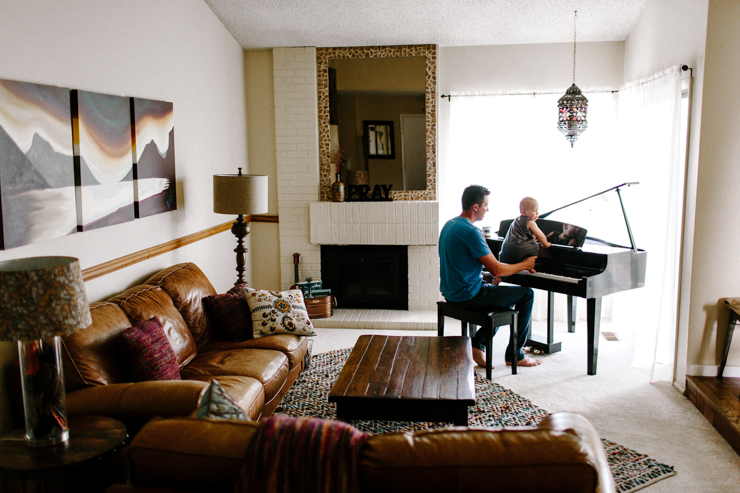 Father and one year old son playing the paino together photography