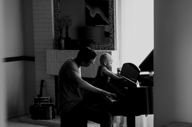 Father and one year old son playing the paino together photography in Colorado