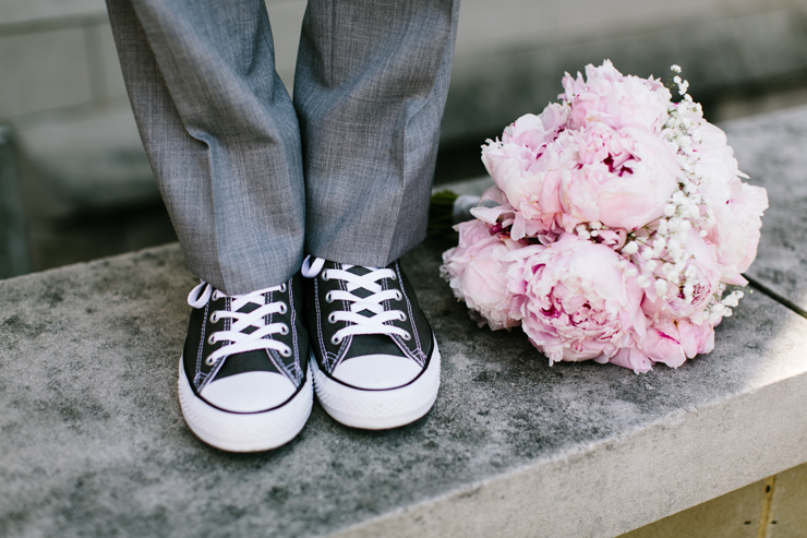 Groom wearing Sneakers with Bride's Bouquet