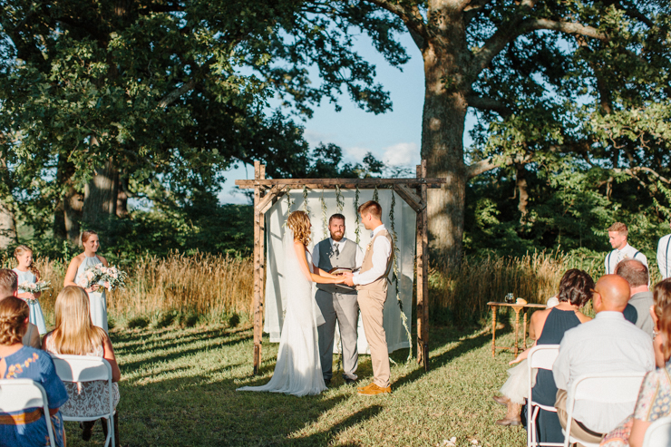 Outdoor ceremony at grandparents' farm at sunset