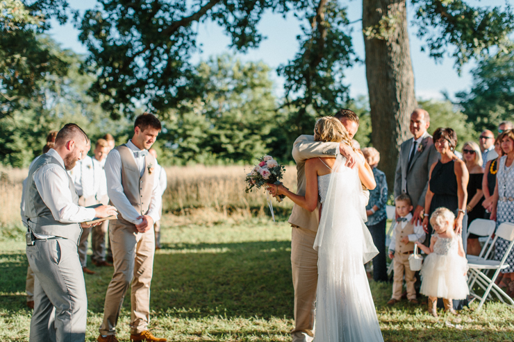 Father giving bride away at wedding ceremony outdoor at grandparents' farm