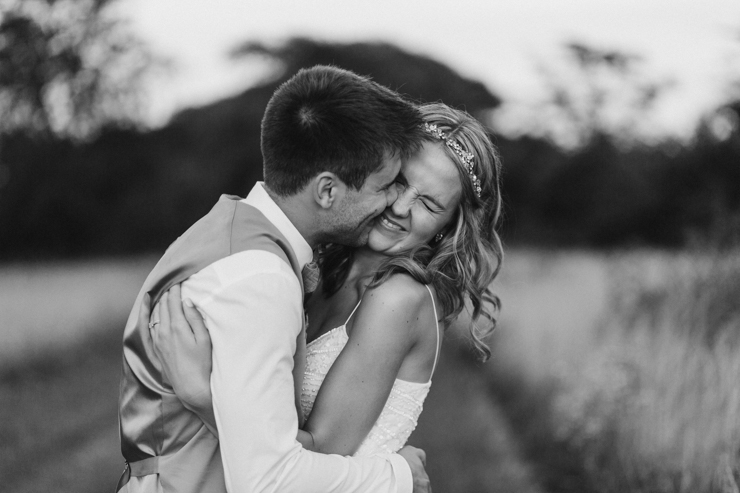 Bride wearing BHLDN Wedding Gown and Groom wearing tan suit intimate wedding portraits