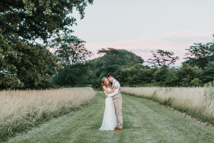 Bride wearing BHLDN Wedding Gown and Groom wearing tan suit intimate wedding portraits