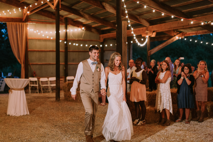 Wedding Reception at Grandparents' family farm and barn decorated with hay bales, quilts, chandeliers, and edison bulbs