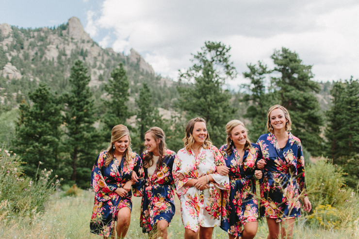 Bridesmaids in floral robes standing in front of the mountains in Estes Park on wedding day