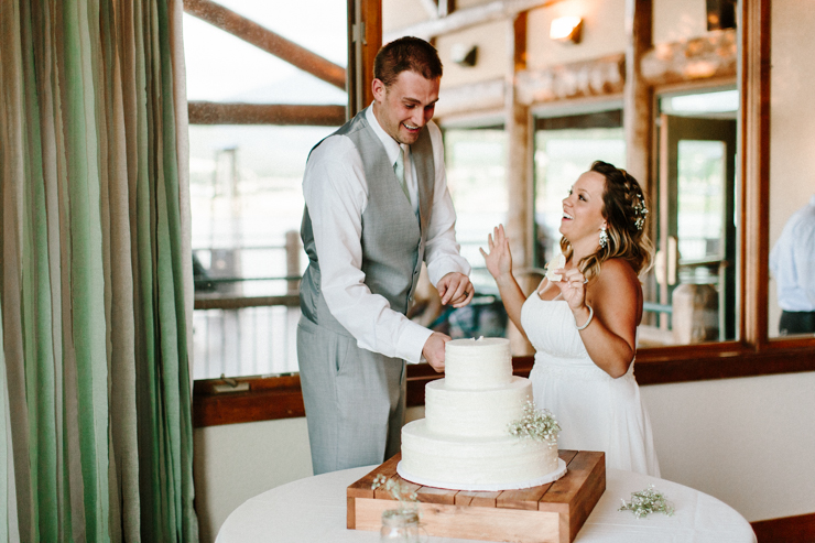 Bride and Groom cut their wedding cake at wedding reception at Estes Park Resort, Colorado