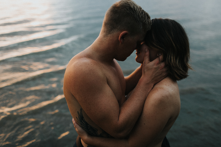 Intimate couple photography nude in the water together 