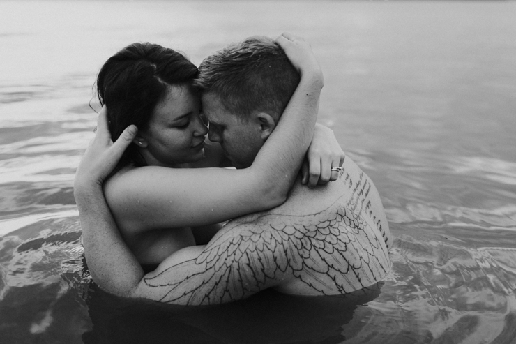 Black and white emotional intimate couple photography in the water together
